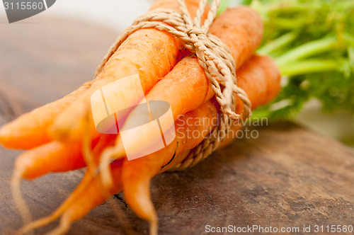 Image of baby carrots bunch tied with rope