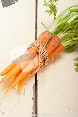 Image of baby carrots bunch tied with rope