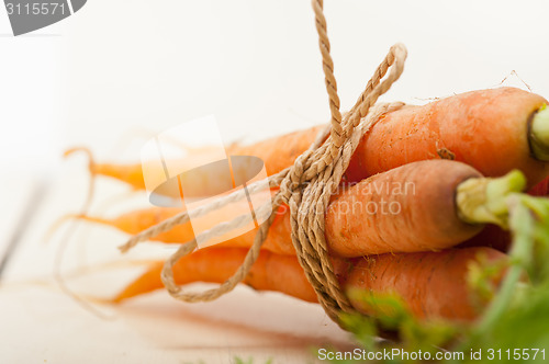 Image of baby carrots bunch tied with rope