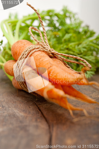 Image of baby carrots bunch tied with rope