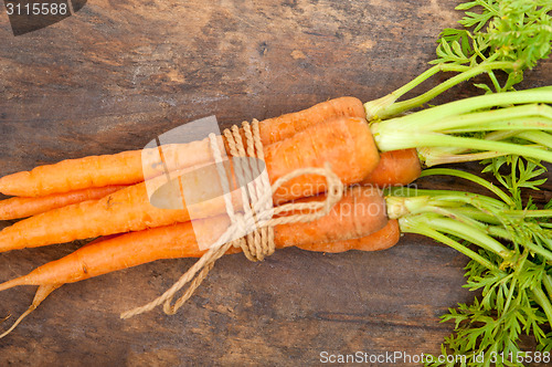 Image of baby carrots bunch tied with rope