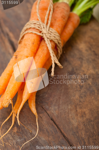 Image of baby carrots bunch tied with rope