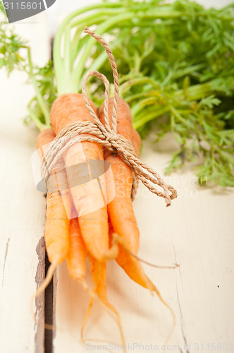 Image of baby carrots bunch tied with rope