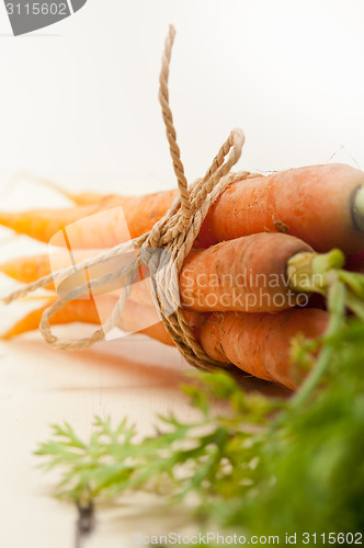 Image of baby carrots bunch tied with rope