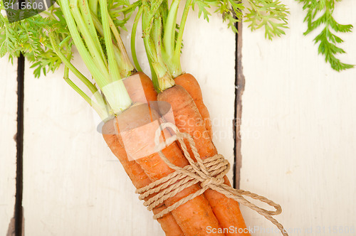 Image of baby carrots bunch tied with rope