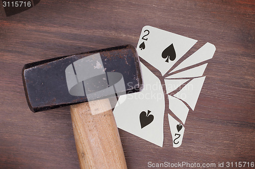 Image of Hammer with a broken card, two of spades