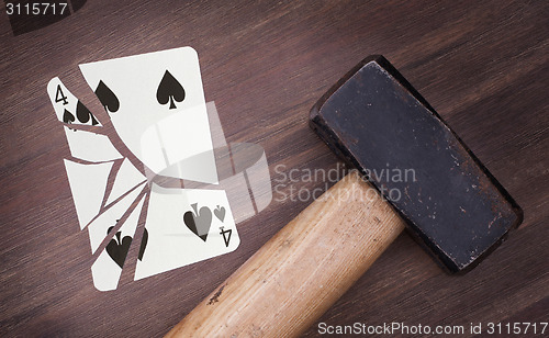 Image of Hammer with a broken card, four of spades