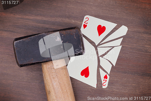 Image of Hammer with a broken card, two of hearts