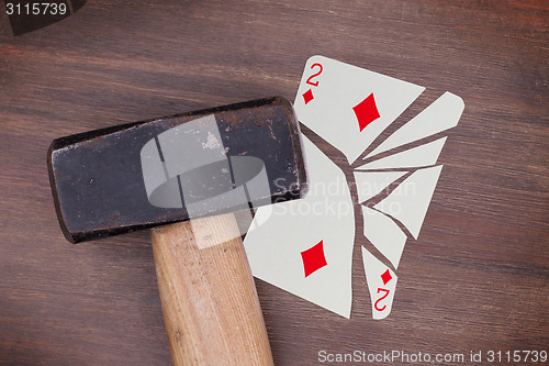 Image of Hammer with a broken card, two of diamonds