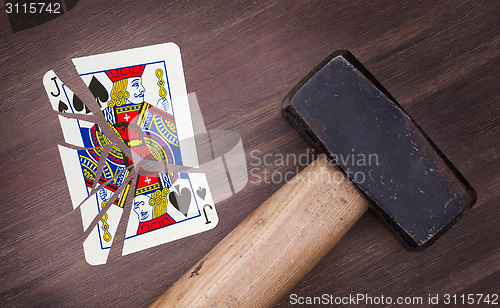 Image of Hammer with a broken card, jack of spades