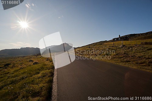 Image of Sun shining on the road through mountain plateau Valdresflye, Jo