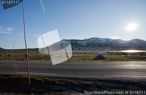 Image of Sun shining on the road through mountain plateau Valdresflye, Jo