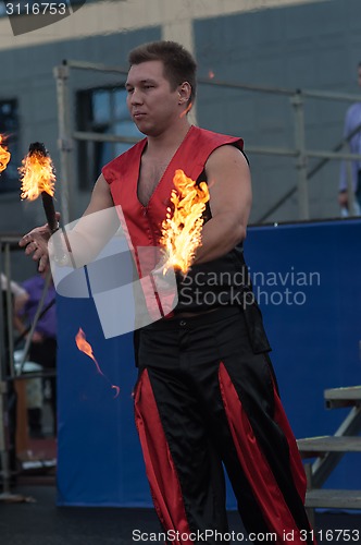 Image of Juggling flaming batons