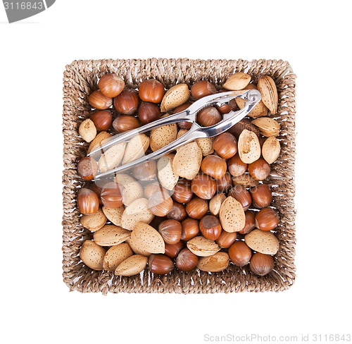 Image of Mixed nuts in a woven basket with nut cracker