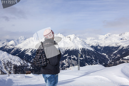 Image of Young man enjoys the view in the mountains