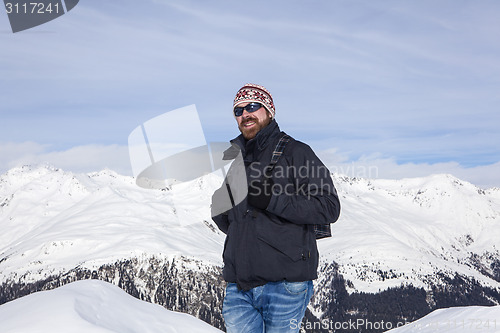 Image of Young man enjoys the view in the mountains