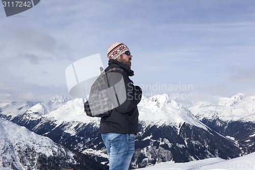 Image of Young man enjoys the view in the mountains