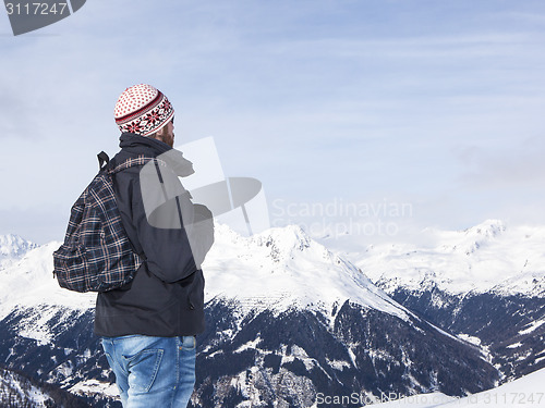 Image of Young man enjoys the view in the mountains