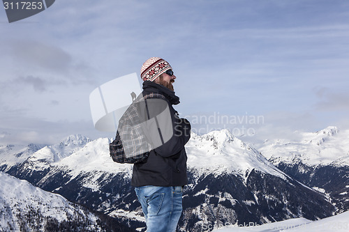 Image of Young man enjoys the view in the mountains