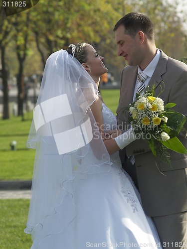 Image of Embracing Just Married in Park