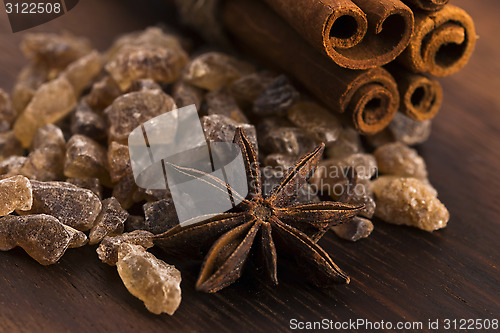 Image of Cinnamon sticks with pure cane brown sugar on wood background