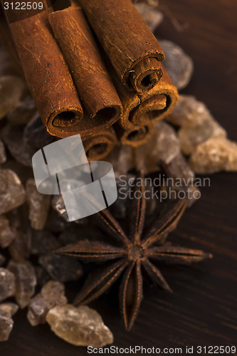 Image of Cinnamon sticks with pure cane brown sugar on wood background