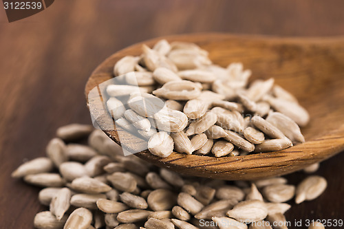 Image of Sunflower seed with a wooden spoon