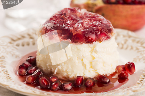 Image of coconut panna cotta dessert with pomegranate