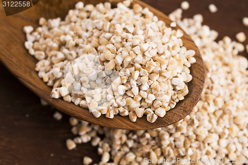 Image of Barley groats on wooden spoon