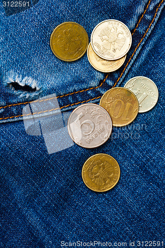 Image of jeans pocket with hole and coins