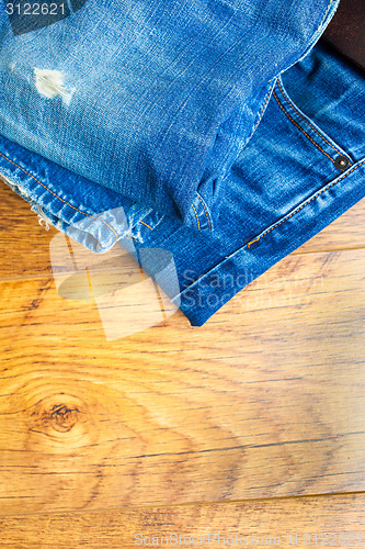 Image of blue jeans on the wooden shelf