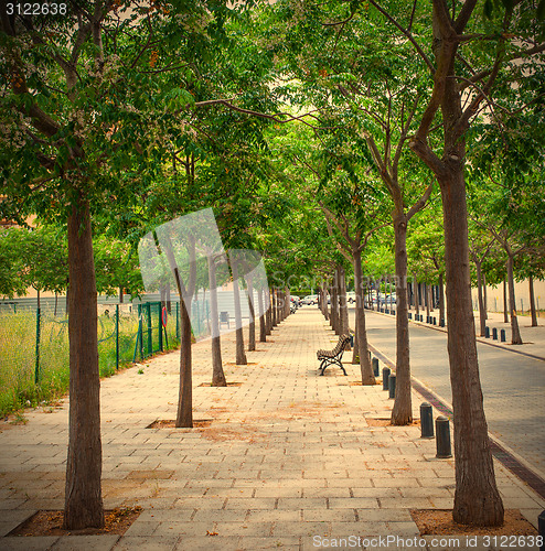 Image of walking alley with bench in a small town