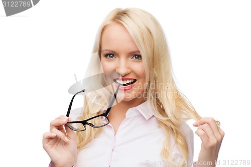 Image of smiling businesswoman or secretary in office