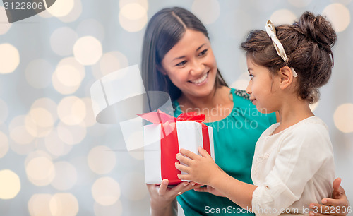 Image of happy mother and daughter with gift box