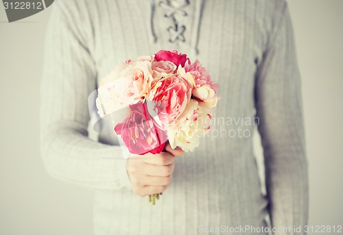 Image of man holding bouquet of flowers