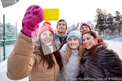 Image of happy friends taking selfie with smartphone