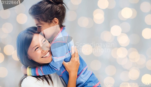 Image of happy mother and daughter hugging