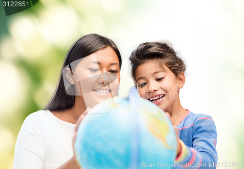 Image of mother and daughter with globe