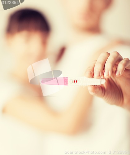 Image of woman and man hands with pregnancy test