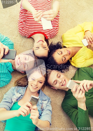 Image of group of smiling people lying down on floor