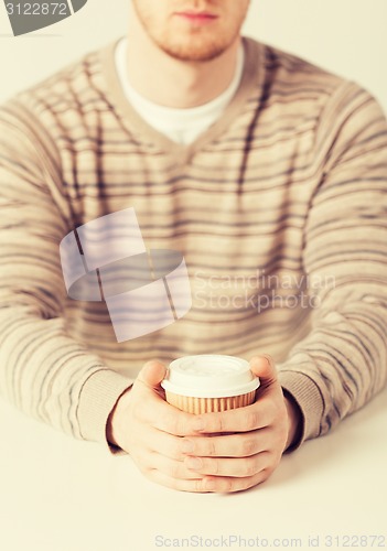 Image of man hand holding take away coffee cup