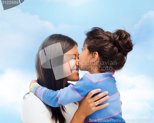 Image of happy little girl hugging and kissing her mother