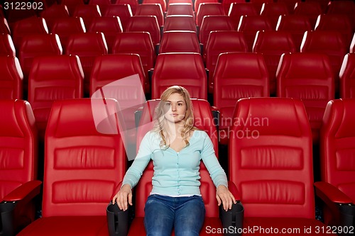 Image of young woman watching movie in theater