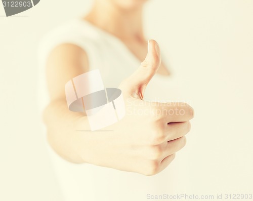 Image of woman showing thumbs up