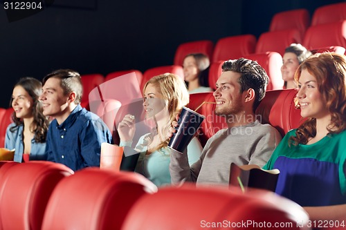 Image of happy friends watching movie in theater