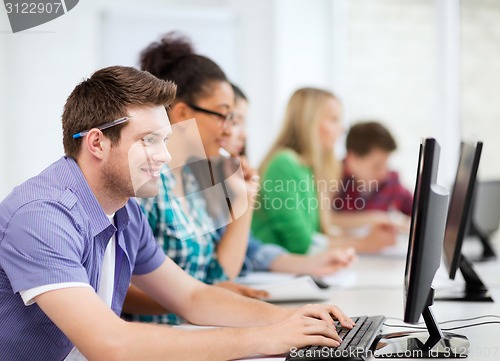 Image of students with computers studying at school