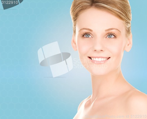 Image of close up of smiling woman over blue background