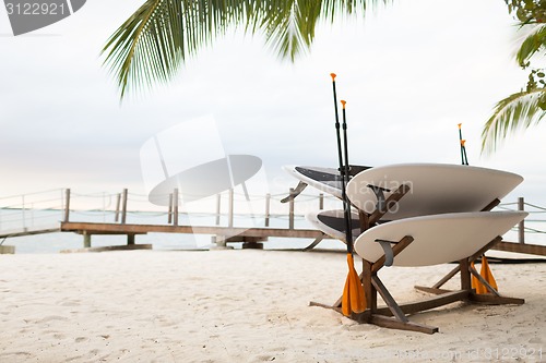 Image of surfboards on tropical beach