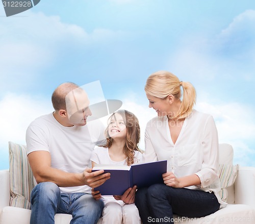 Image of happy family with book at home
