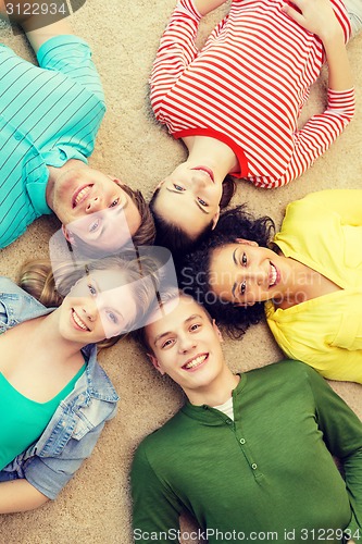 Image of group of smiling people lying down on floor